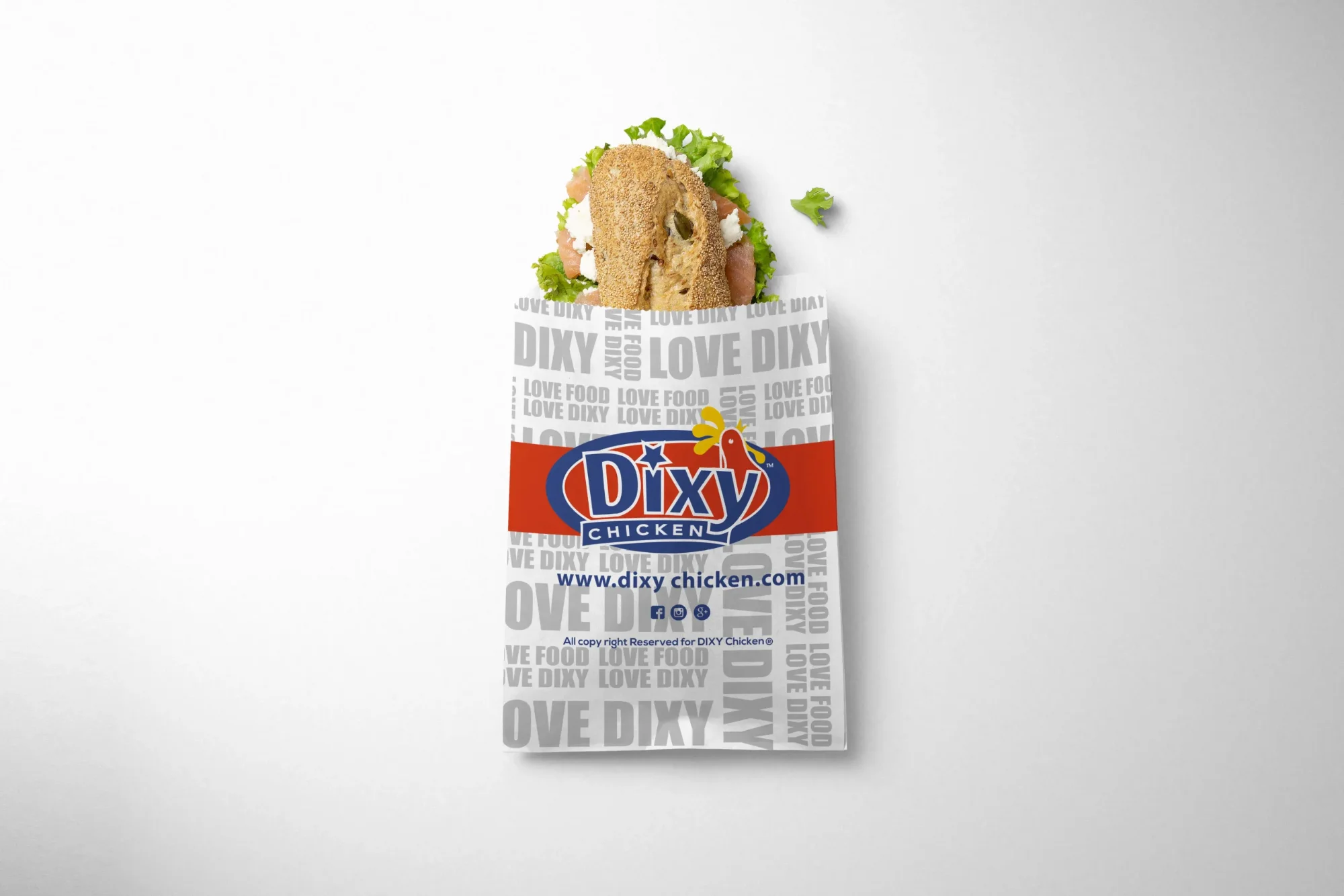 Bagel sandwich with salmon and fresh greens in Dixy Chicken branded wrapper on clean white background